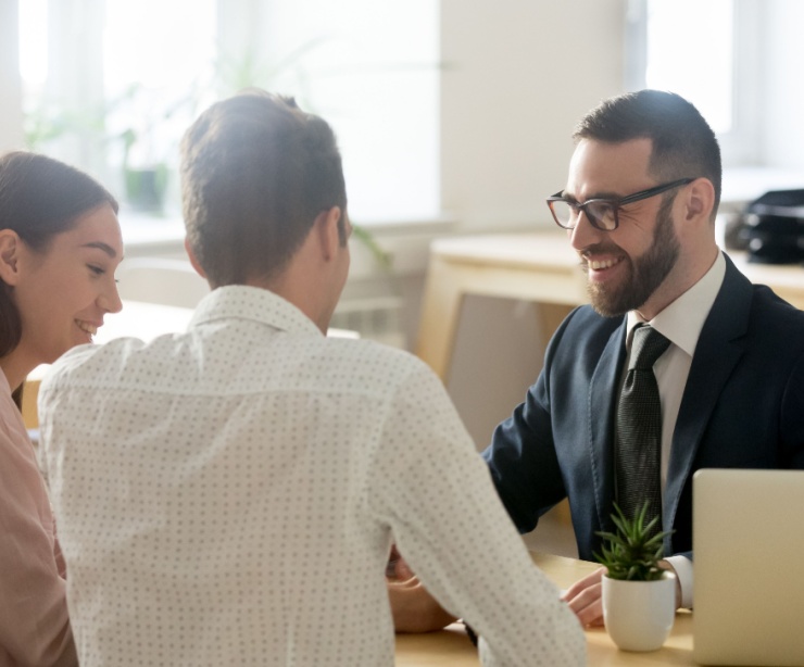 A young couple meeting with a financial planner.